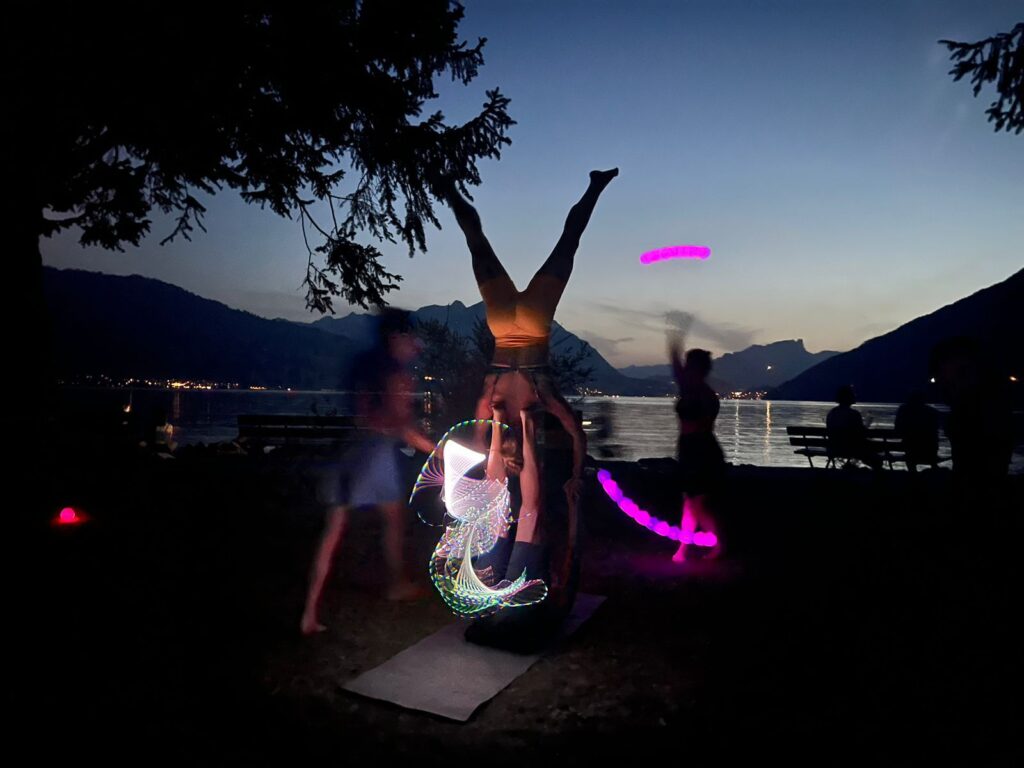 The MOVE Interlaken Crew doing FlowArts and AcroYoga at night at Kifferinseli.
